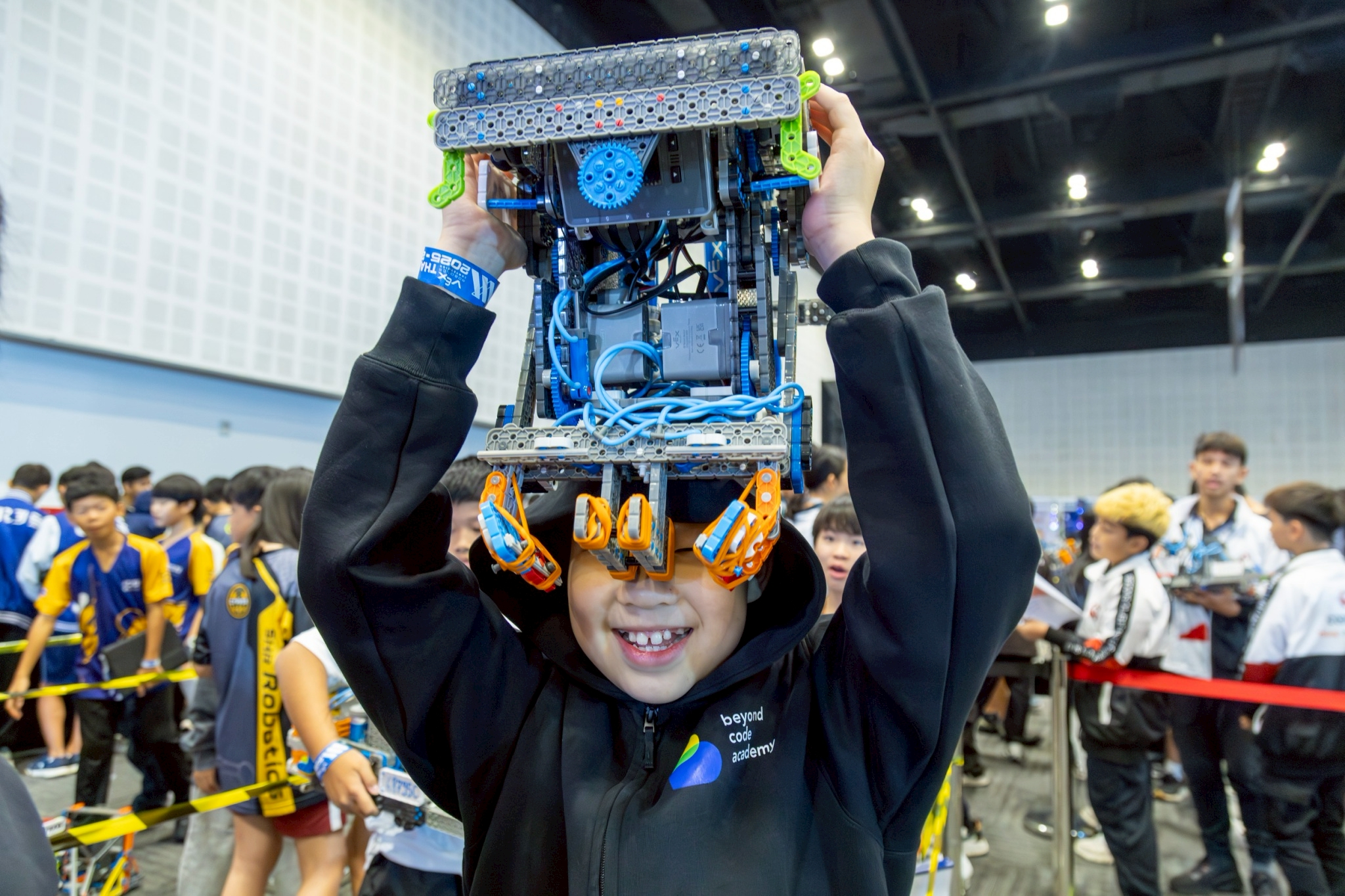 Beyond Code Academy student holding a VEX IQ robot at competition